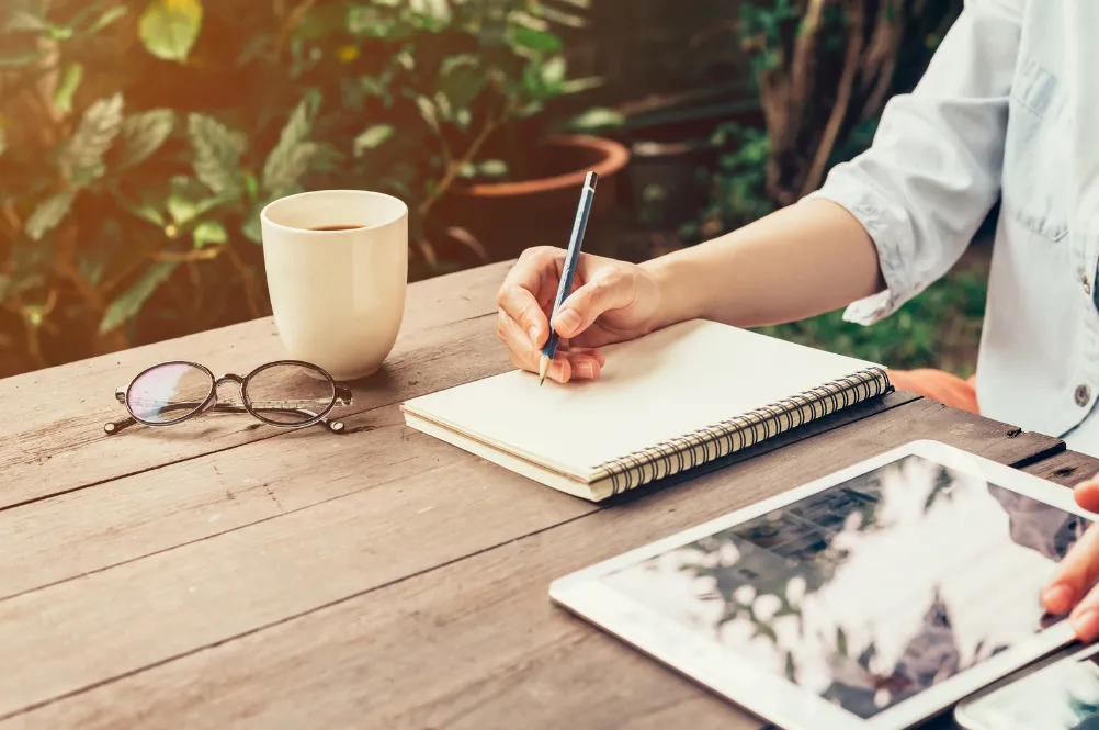 young woman writing at a table