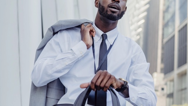 young man walking with briefcase