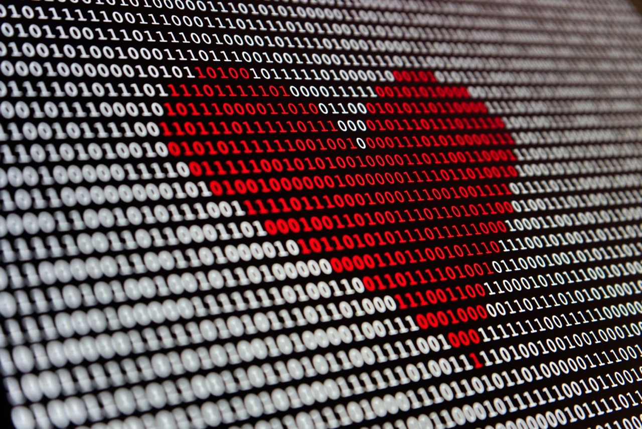 a red heart on a screen of binary code