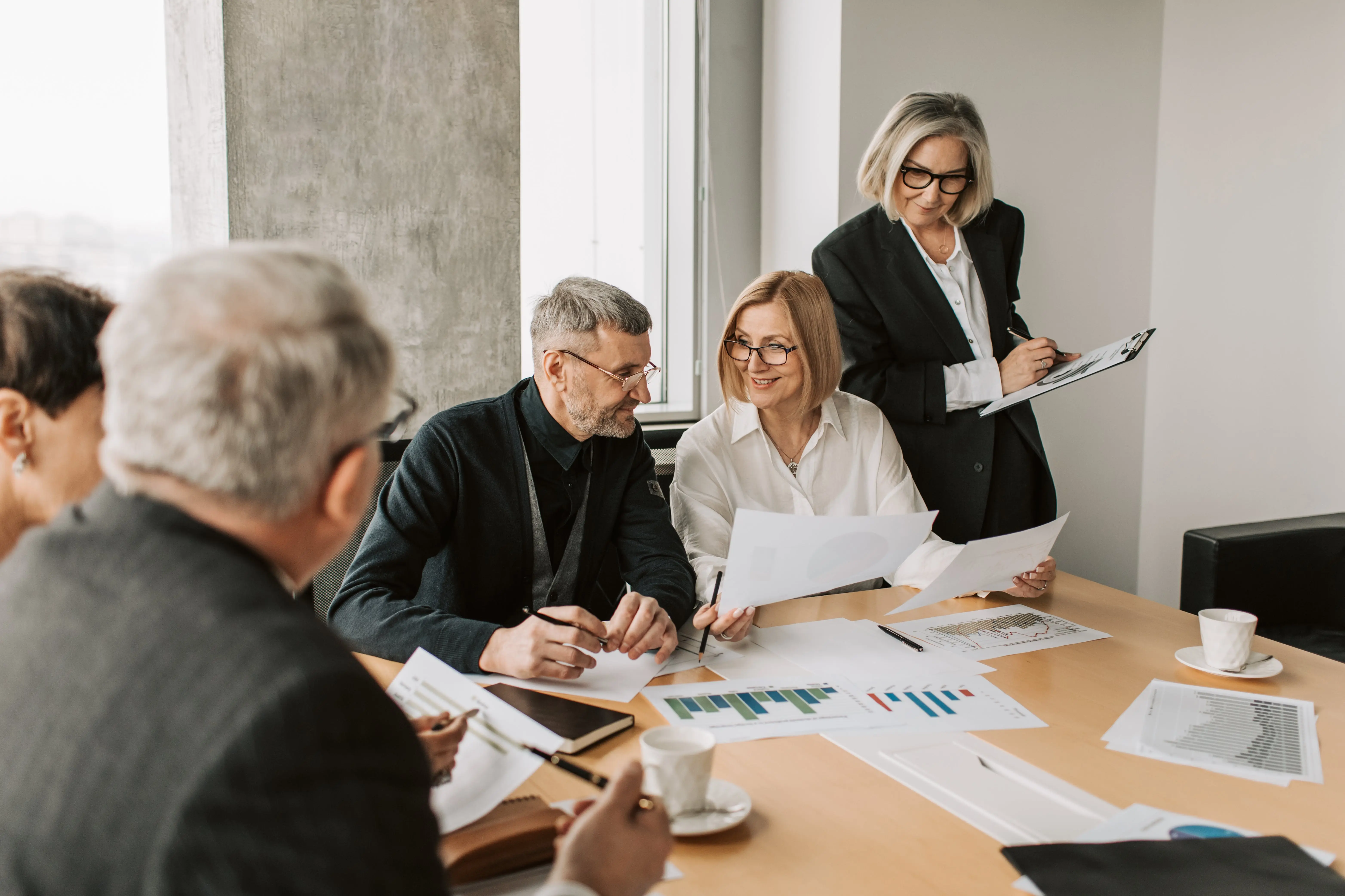 a group of business people working at a table